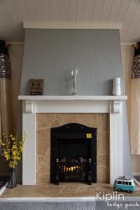 a fireplace with a white mantle with a fire place at Rutland in Richmond