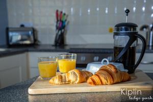 a cutting board with croissants and two glasses of orange juice at Rutland in Richmond