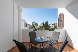 a balcony with a table and chairs and a window at El Zoco de Iñaki - Adults Only in Sitio de Calahonda