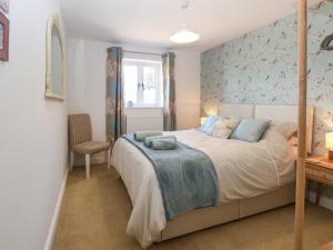 a bedroom with a large bed and a window at Beck View in Norwich