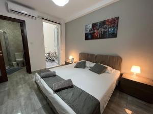 a bedroom with a large white bed with two pillows at F7-1 Double room with private bathroom in shared Flat in Msida