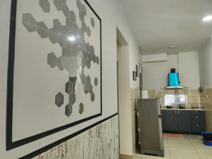 a kitchen with a large picture on the wall at Relax Bear Homestay in Tanah Rata