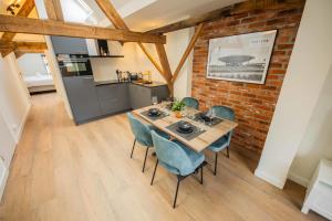 een eetkamer met een tafel en stoelen en een bakstenen muur bij Spectacular 70m2 Penthouse with Terrace in Eindhoven