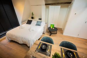 een slaapkamer met een bed en een tafel en stoelen bij Spectacular 70m2 Penthouse with Terrace in Eindhoven