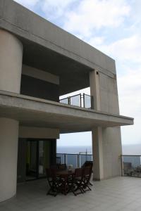 a balcony of a house with a table and chairs at Benidorm Skyline in Benidorm