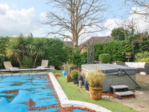 a swimming pool in the backyard of a house at Maples Annex in Heanor