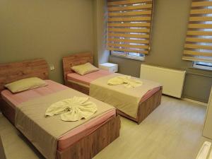 Una cama o camas en una habitación de SAMSUN AMAZON OTEL