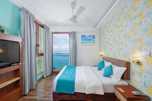 a hotel room with a bed and a large window at h78 in Hulhumale