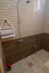 a shower with a glass door in a bathroom at النقره خلف العثيم مول 4 in Hail