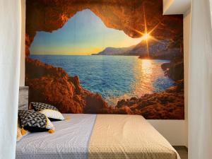 a bedroom with a view of the ocean from a cave at L'Étoile de Mer - Étretat in Le Havre