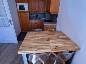 a kitchen with a wooden table with two chairs at Appartement Valloire, 2 pièces, 4 personnes - FR-1-263-189 in Valloire
