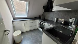 a small kitchen with a sink and a window at Casa Bella in Weeze