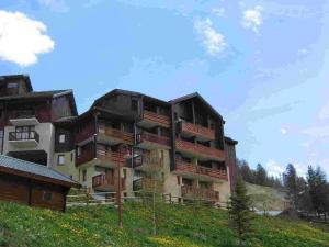 an apartment building with balconies on the side of a hill at Studio Peisey-Vallandry, 1 pièce, 4 personnes - FR-1-411-137 in Landry