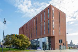 a brick building with a sign on the side of it at Hilton Garden Inn Stoke On Trent in Stoke on Trent