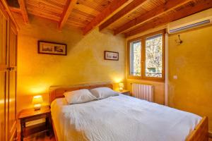 a bedroom with a bed with two tables and two lamps at Villa Provence Vue Panoramique in Fayence +24 photos