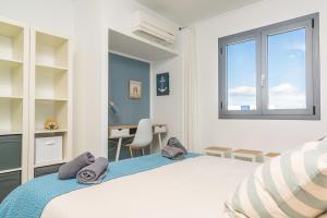 a bedroom with a bed and a desk and a window at Casa del Mar in Son Serra de Marina +43 photos