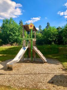 a playground with a slide in a park at Hotel Europa in Ramstein-Miesenbach