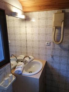 a bathroom with a sink and a mirror at Altis Val Vert in Brides-les-Bains