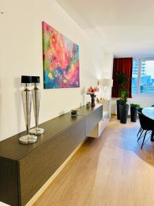 a living room with a table and a painting on the wall at Urbanstay Suites Grand Place Luxury Apartment in Brussels