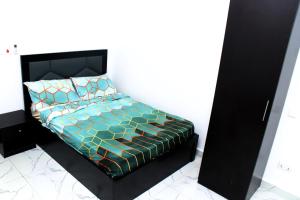 a bedroom with a bed with a black headboard at Zion Luxury Retreat in Igaun