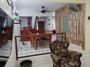 a living room with a chair and a table at Homestay Shah Alam OneB, 2-12 pax, I-city & UiTM in Shah Alam +13 photos