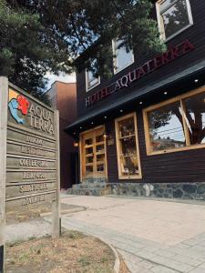 a building with a sign in front of it at Hotel Aquaterra in Puerto Natales