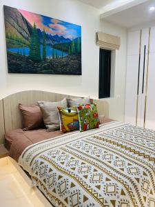 a bedroom with a bed with a painting on the wall at Krabi Aonang & Alpha villa in Ao Nam Mao +37 photos
