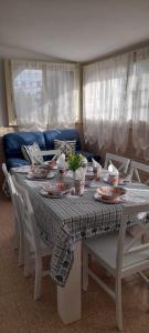 tavolo da pranzo con piatti e stoviglie di Villa Rifla Attico a Lizzano