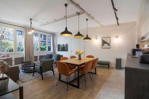 een eetkamer en een woonkamer met een tafel en stoelen bij Brand new flat for 8 people, 3 bedrooms in Parijs