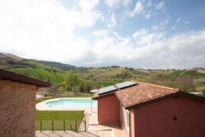 an external view of a house with a swimming pool at Depandace Lavanda in Castignano