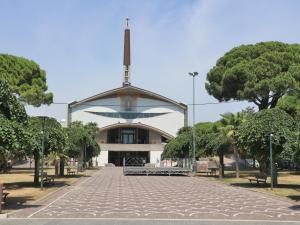 a building with a cross on the top of it at Occidente in Lignano Sabbiadoro