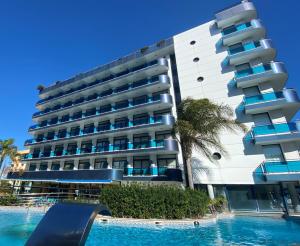 een hotel met een zwembad voor een gebouw bij Hotel Blaucel in Blanes