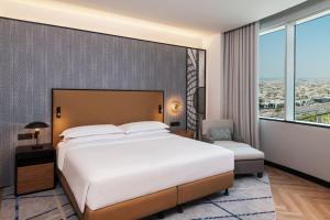 a bedroom with a large bed and a large window at Sheraton Mall of the Emirates Hotel, Dubai in Dubai