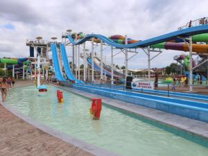a water park with a water slide in the water at Occidente in Lignano Sabbiadoro