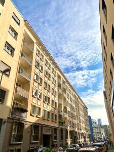 a large building with cars parked in front of it at CitySerenity Rustic Apartment in Bratislava