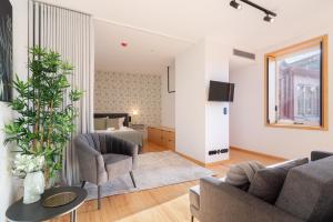 a living room with a couch and a table at Luxurious Bright Flats - Ace Location in Porto