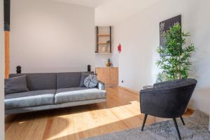 a living room with a couch and two plants at Luxurious Bright Flats - Ace Location in Porto