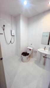 a bathroom with a toilet and a sink at เสาวลักษณ์ เรสซิเด้นท์ in Khon Kaen