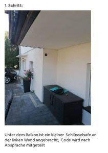 an outdoor patio with a black table in front of a building at Gemütliches Appartment in Homberg Stadtmitte in Homberg