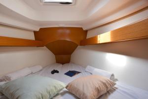 a bedroom with a bed with two pillows at Sun odyssey 43ia in Corfu Town