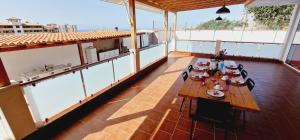 a balcony with a table and chairs on it at Bright 4 bedroom Villa, Pool and Tennis court in Playa Paraiso