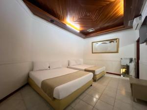a bedroom with two beds in a room at Hotel Barranquilla Prado in Barranquilla