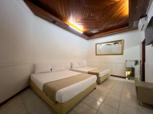 Giường trong phòng chung tại Hotel Barranquilla Prado