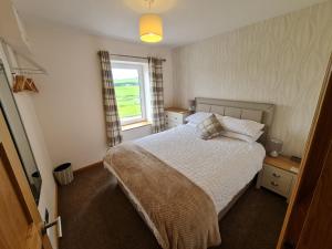 a small bedroom with a bed and a window at Bruxie Holiday Cottages - River Cottage in Maud