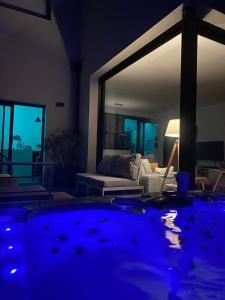 a living room with a couch and a table at Vue mer Bretagne Villa d'architecte in Plérin