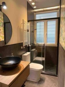 a bathroom with a sink and a glass shower at City Central By Sleep In Bilbao in Bilbao