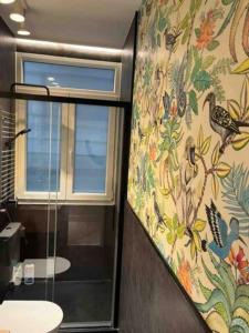 a bathroom with a window and a curtain with birds on it at City Central By Sleep In Bilbao in Bilbao