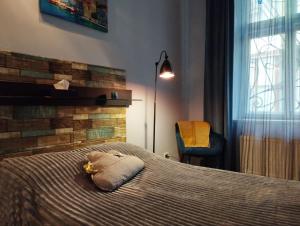 a bedroom with a bed with a stuffed animal on it at Family Stay in Lviv (2 Rooms + Kitchen) in Kulʼparkuv