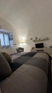 a bedroom with two beds and a tv on the wall at Elly’s House in Bari