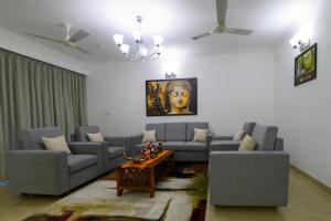 a living room with two couches and a coffee table at Lotus & Orchid Villas by Ramnath Homes in Sangolda